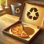 A realistic, horizontal image for a blog post about recycling pizza boxes, showing a close-up of an open pizza box with one half clean and the other half greasy